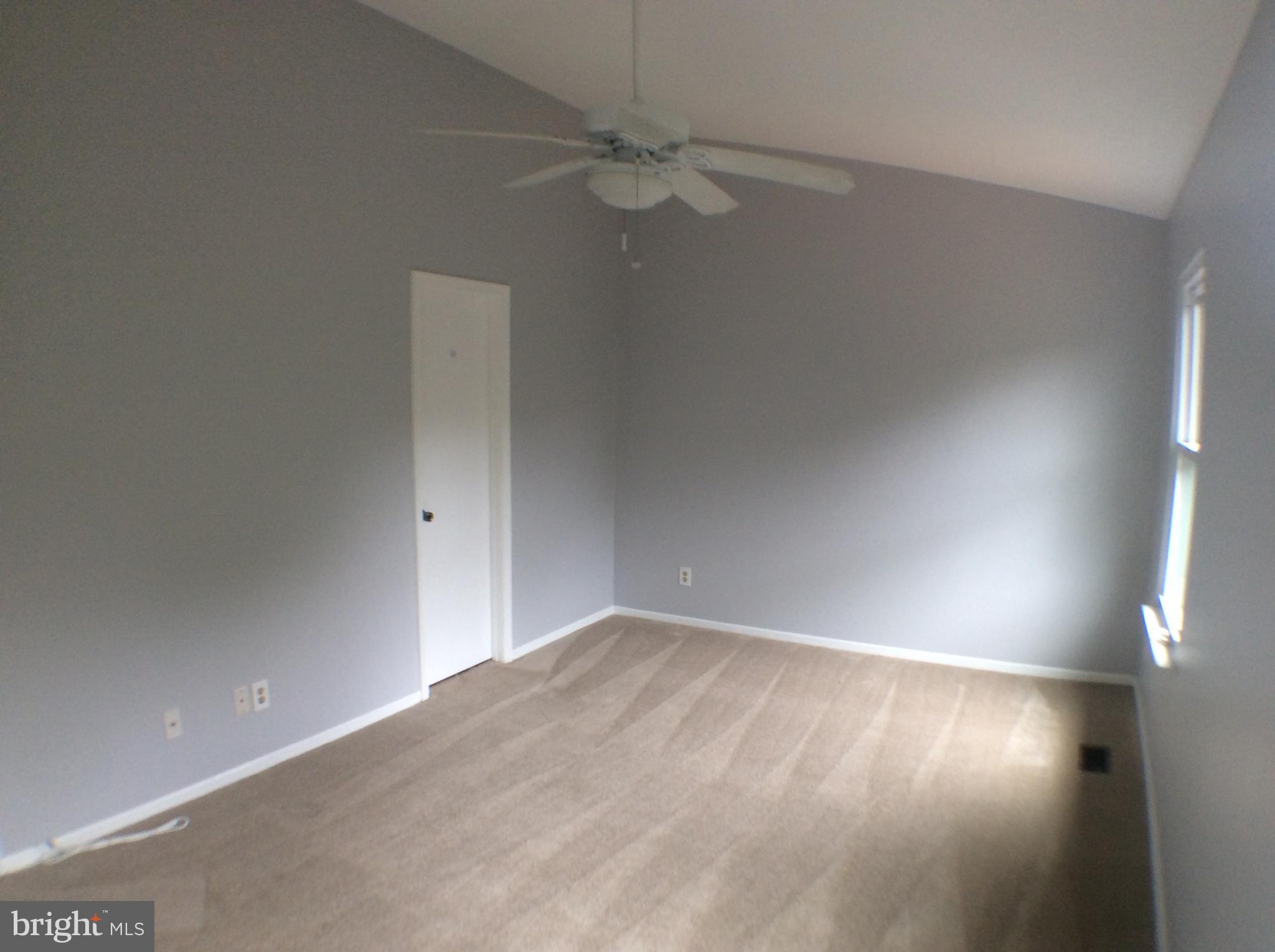 2021 Putnam Road Baltimore, MD 21227 - Photo 11 of 18 an empty room with a ceiling fan and a window
