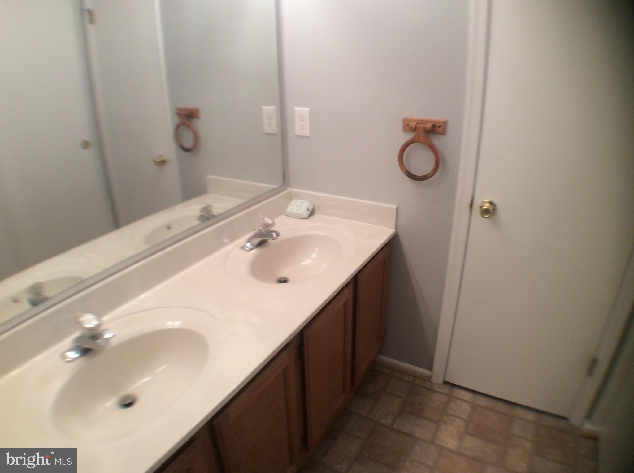 2021 Putnam Road Baltimore, MD 21227 - Photo 13 of 18 a bathroom with a sink and a mirror
