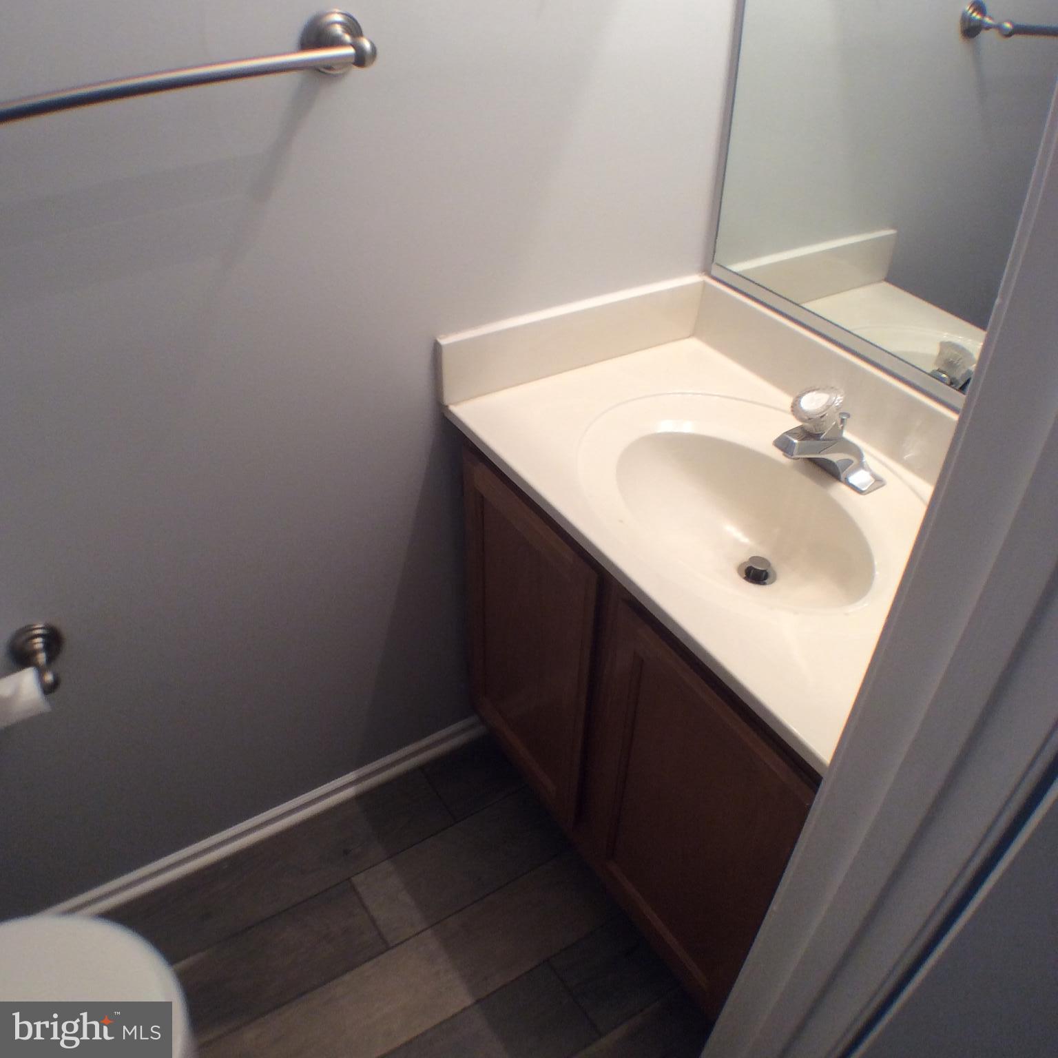 2021 Putnam Road Baltimore, MD 21227 - Photo 3 of 18 a bathroom with a sink and a mirror