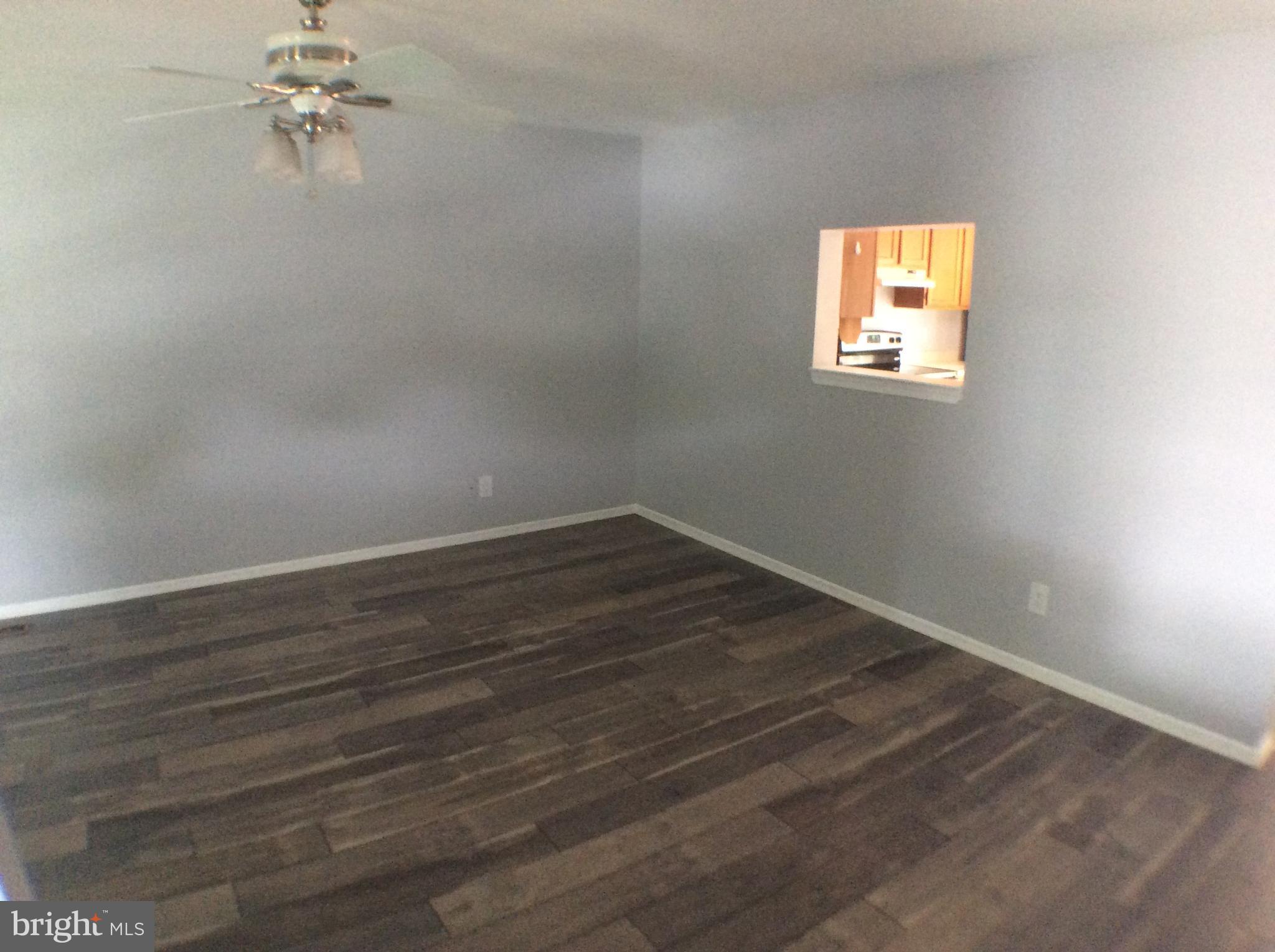 2021 Putnam Road Baltimore, MD 21227 - Photo 6 of 18 wooden floor in an empty room