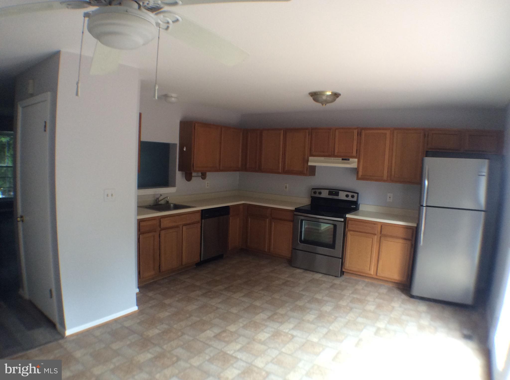 2021 Putnam Road Baltimore, MD 21227 - Photo 7 of 18 a kitchen with a refrigerator sink and stove