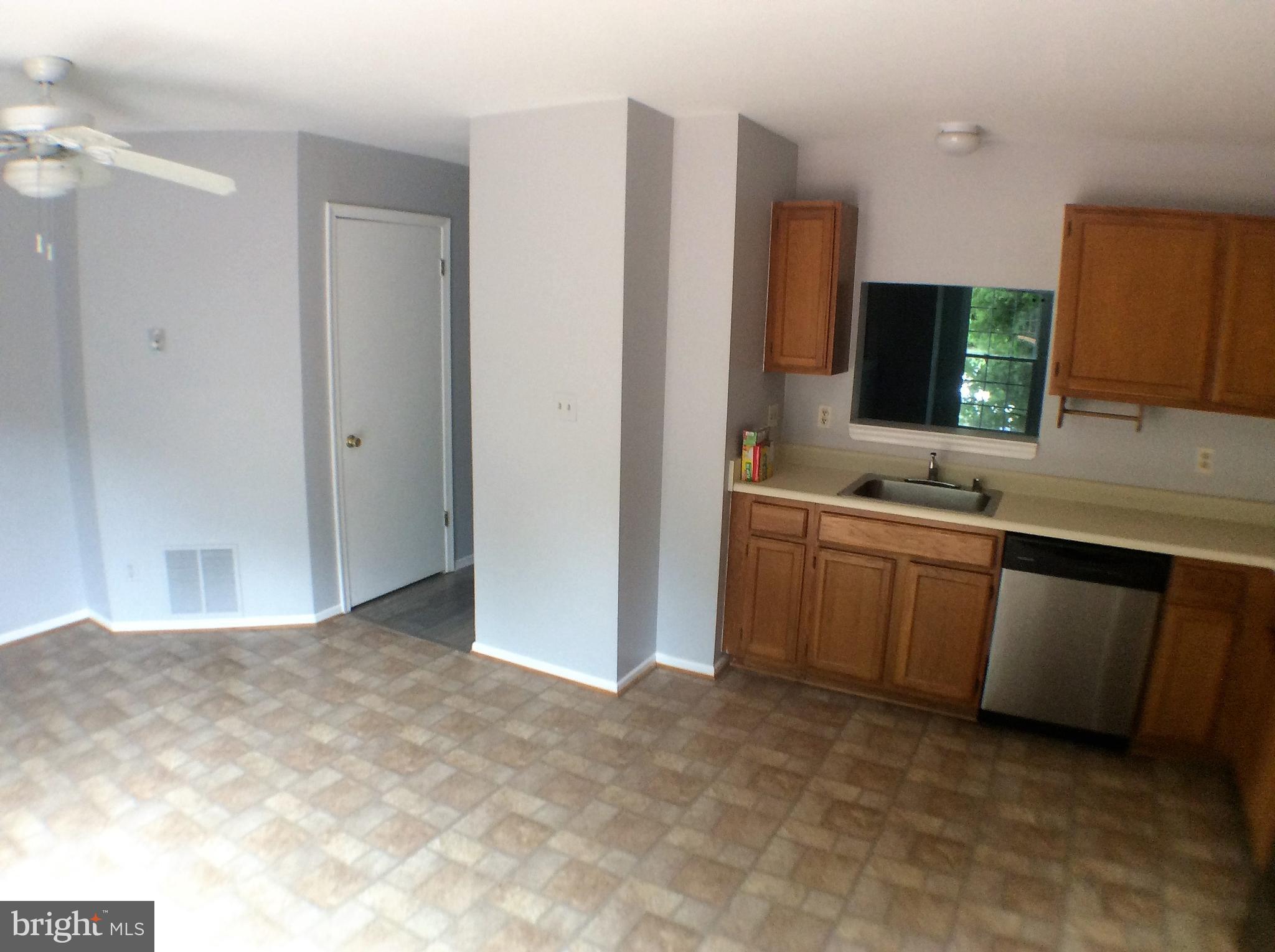 2021 Putnam Road Baltimore, MD 21227 - Photo 8 of 18 a kitchen with stainless steel appliances a sink and a refrigerator