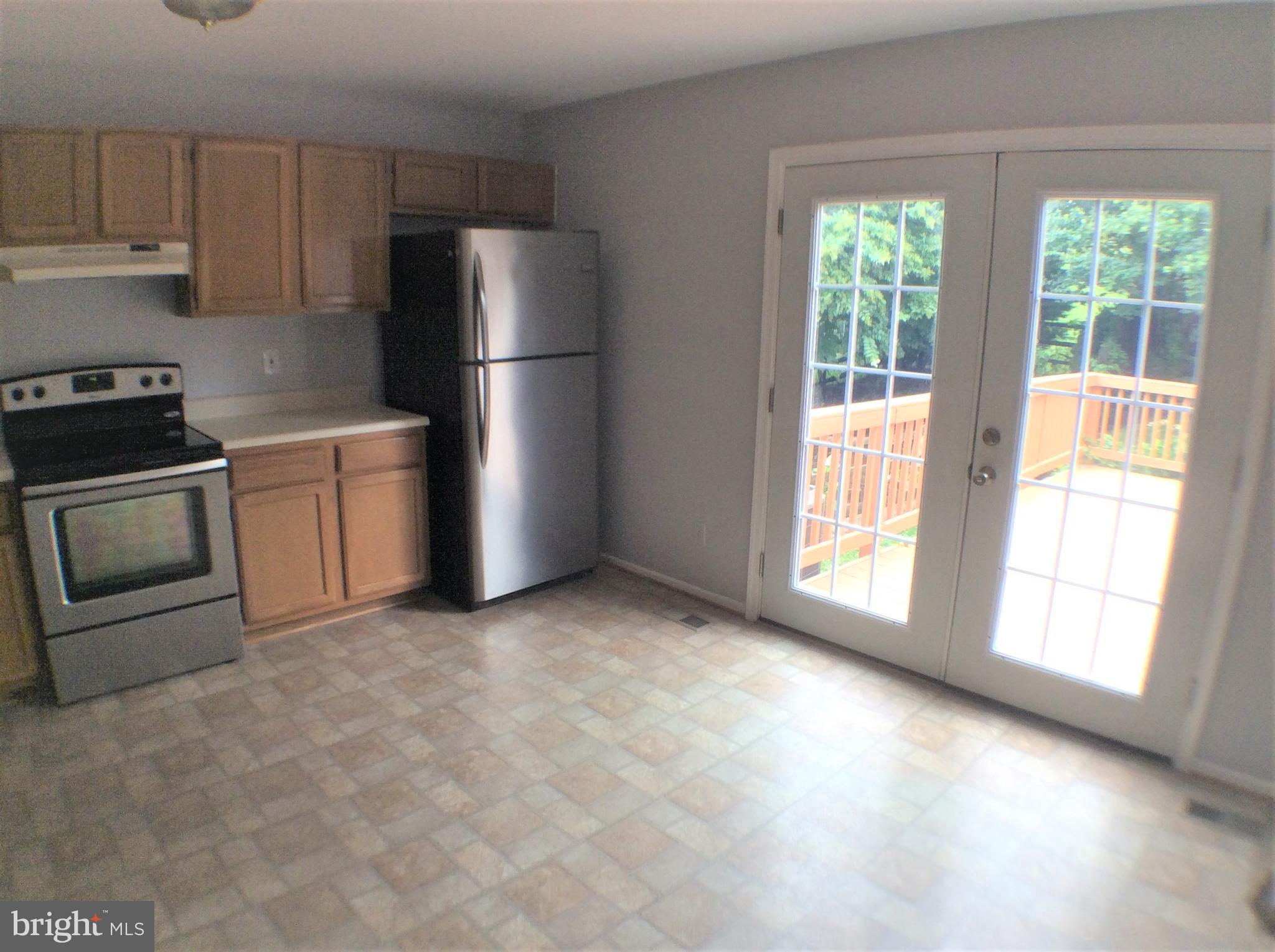 2021 Putnam Road Baltimore, MD 21227 - Photo 9 of 18 a kitchen with stainless steel appliances a refrigerator a stove a microwave and cabinets