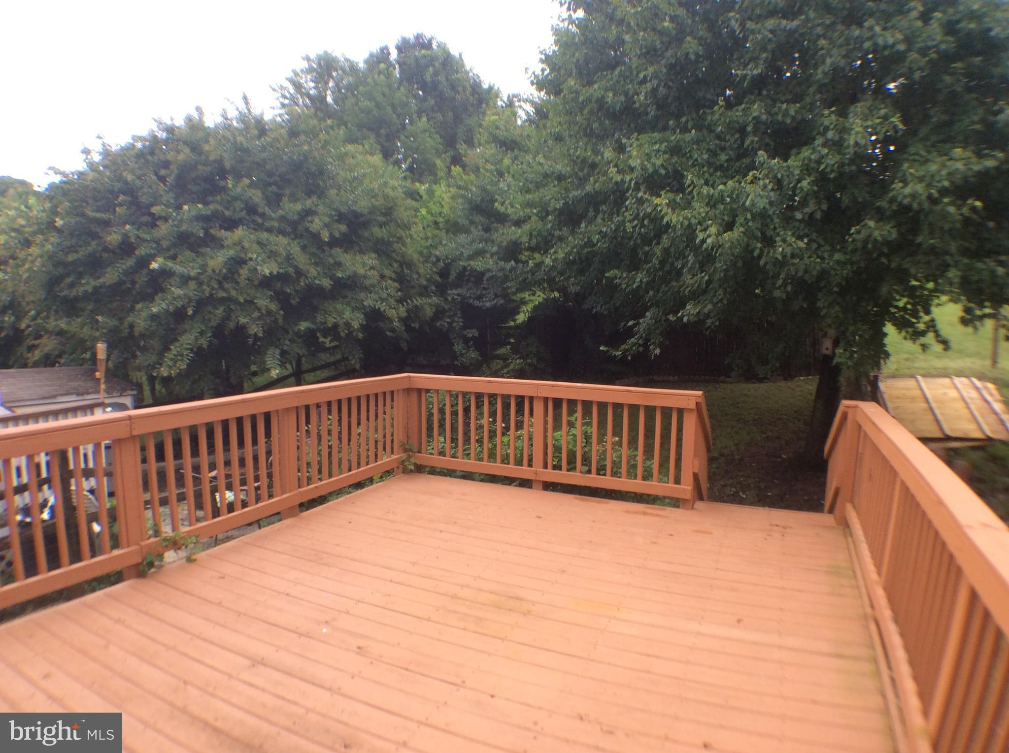 2021 Putnam Road Baltimore, MD 21227 - Photo 10 of 18 a view of balcony with wooden floor and fence