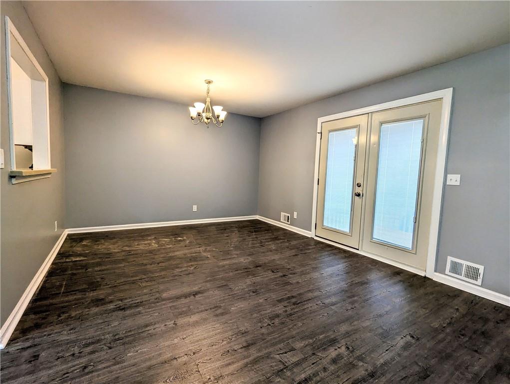 4990 Mountain Springs Way Stone Mountain, GA 30083 - Photo 3 of 9 a view of an empty room with wooden floor and a window