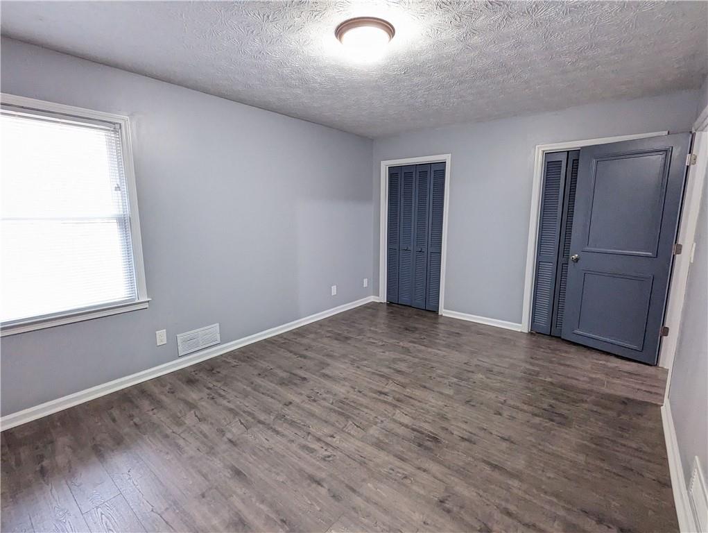 4990 Mountain Springs Way Stone Mountain, GA 30083 - Photo 6 of 9 wooden floor in an empty room with a window