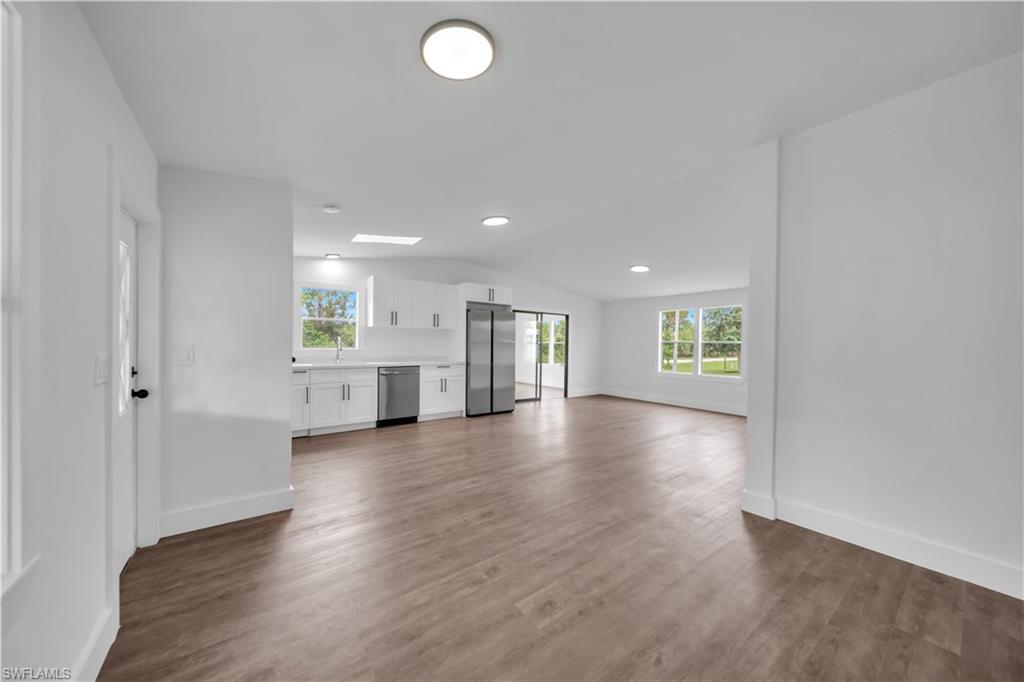 11562 Royal Road Punta Gorda, FL 33955 - Photo 4 of 13 Open concept living area with wood-finish flooring