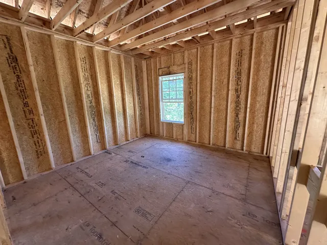 a view of a room with a shower and a chair