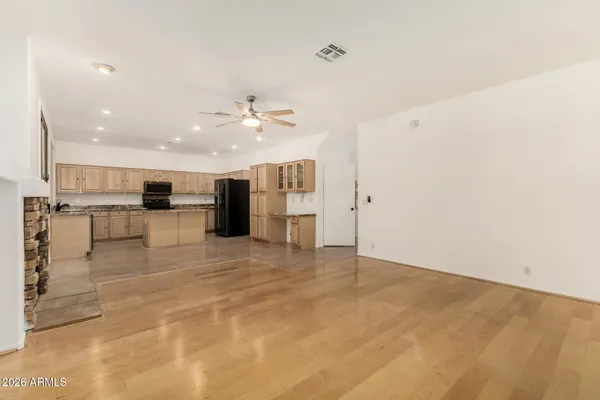 a kitchen with kitchen island granite countertop a stove sink and cabinets