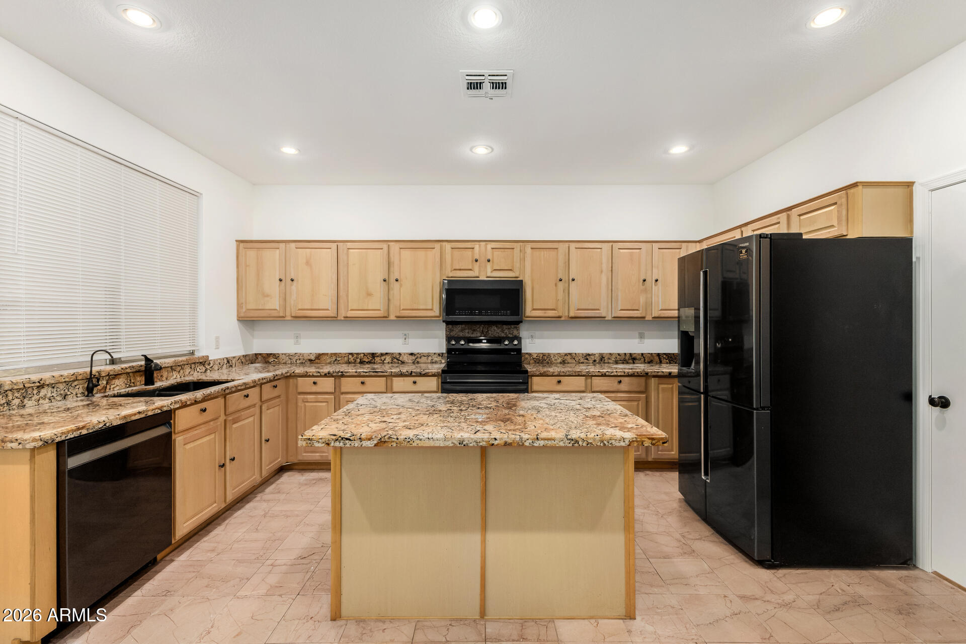 3962 East Agave Road Phoenix, AZ 85044 - Photo 12 of 54 a kitchen with stainless steel appliances granite countertop a refrigerator and a stove