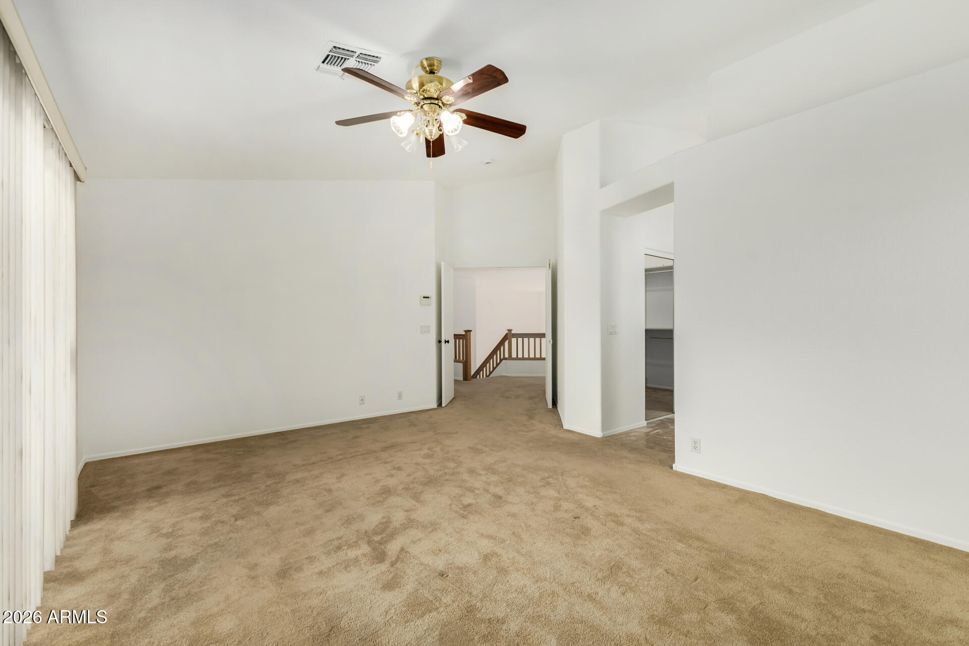3962 East Agave Road Phoenix, AZ 85044 - Photo 19 of 54 an empty room with chandelier fan and closet