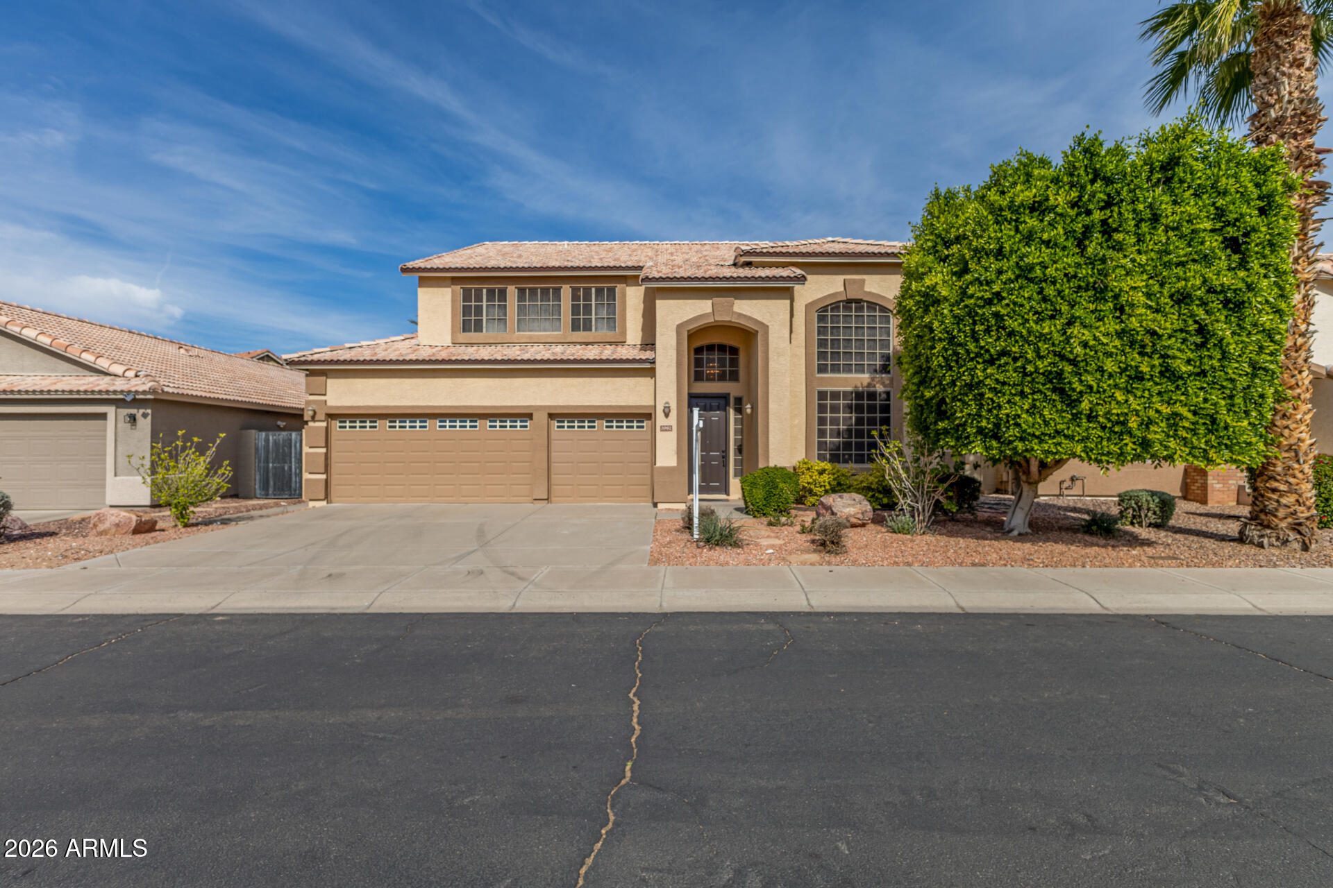 3962 East Agave Road Phoenix, AZ 85044 - Photo 42 of 54 a front view of a house with a yard and garage