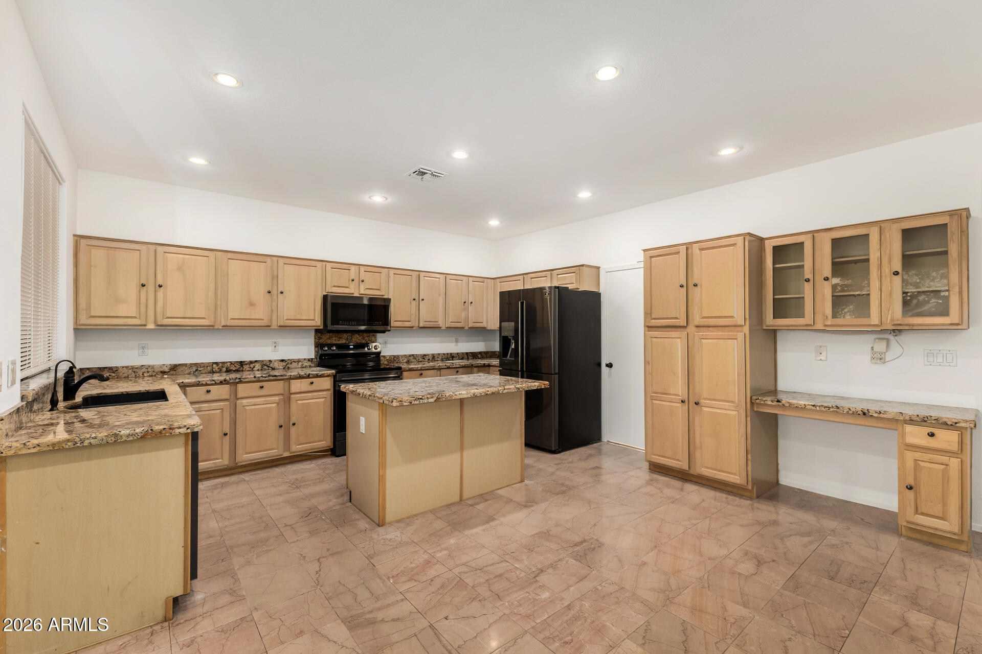 3962 East Agave Road Phoenix, AZ 85044 - Photo 5 of 54 a kitchen with stainless steel appliances granite countertop a refrigerator sink and stove