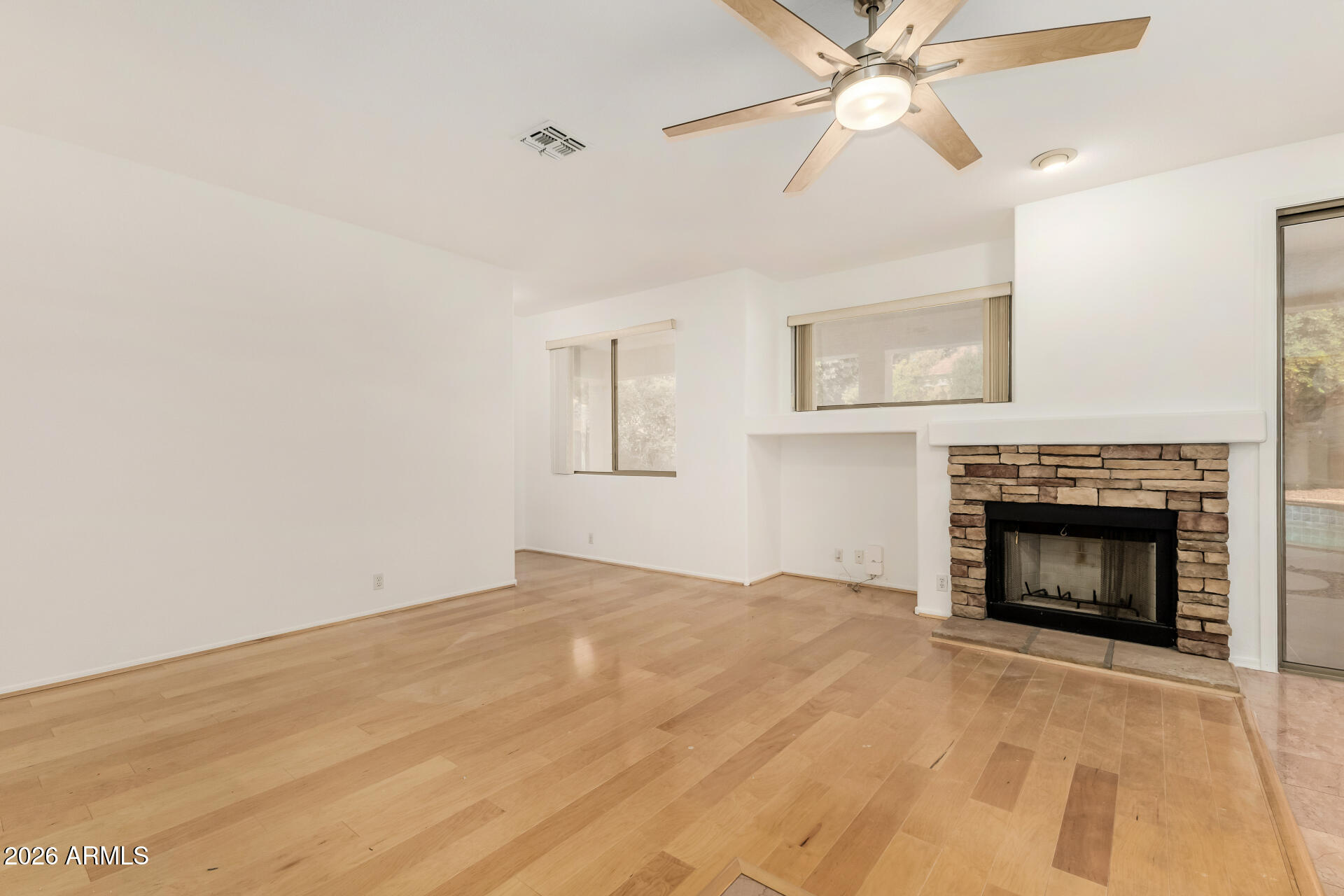 3962 East Agave Road Phoenix, AZ 85044 - Photo 10 of 54 a view of empty room with a fireplace and fan