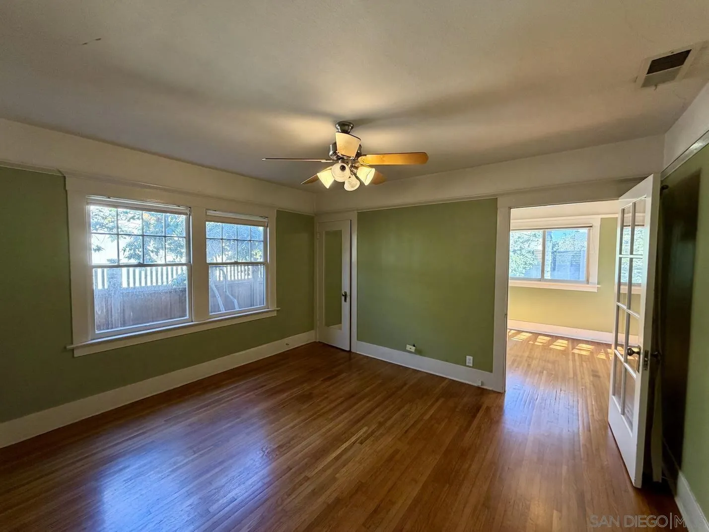 3917 Hawk Street San Diego, CA 92103 - Photo 18 of 40 a view of an empty room with wooden floor and a window