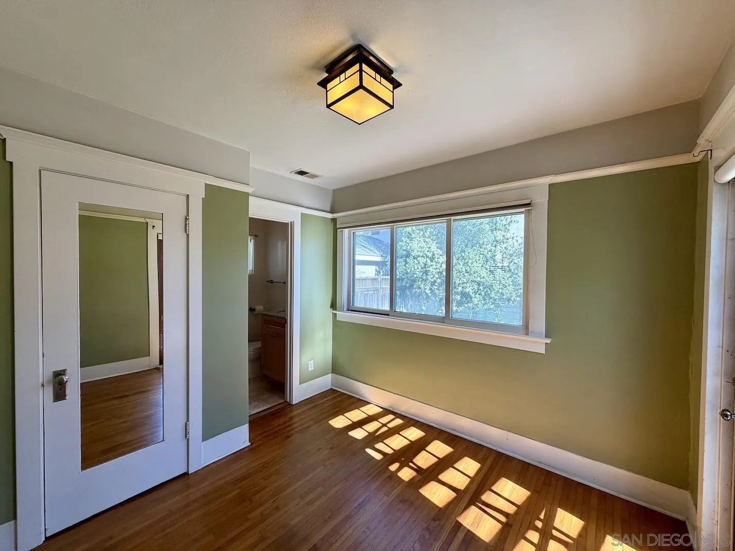 3917 Hawk Street San Diego, CA 92103 - Photo 20 of 40 a view of an empty room with wooden floor and a window