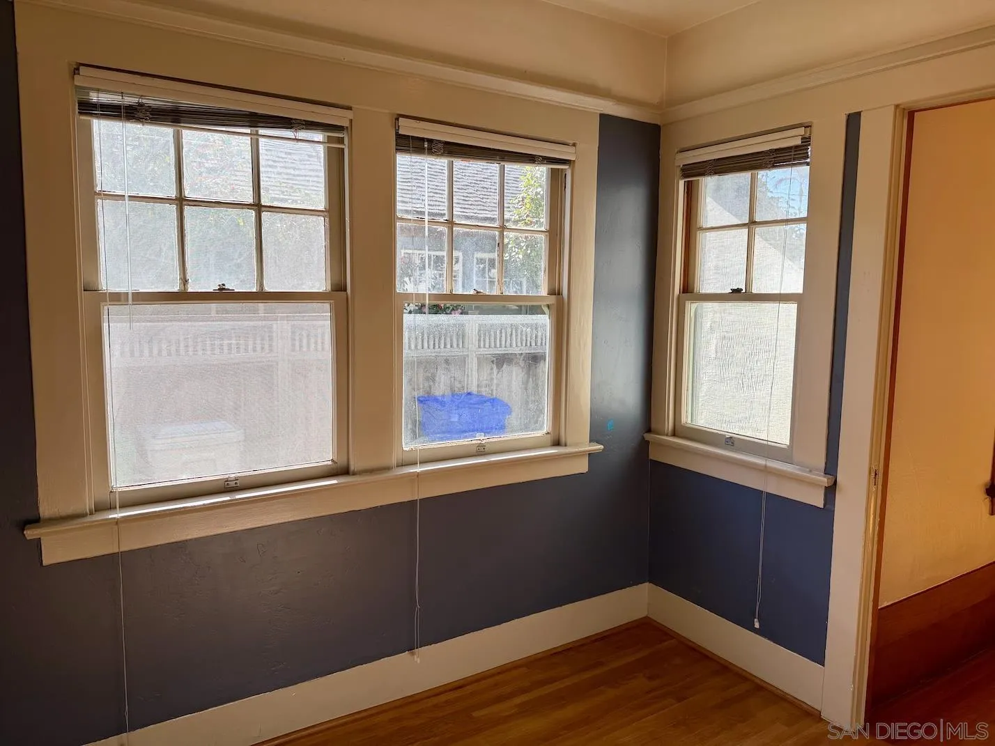 3917 Hawk Street San Diego, CA 92103 - Photo 21 of 40 a view of an empty room with wooden floor and a window