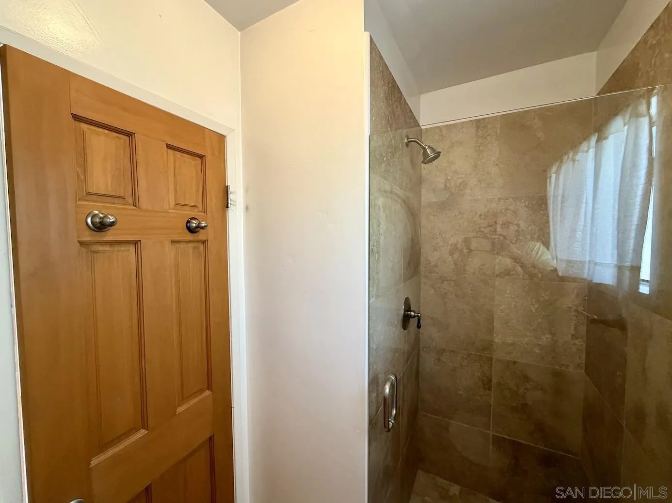 3917 Hawk Street San Diego, CA 92103 - Photo 22 of 40 a bathroom with a shower and a glass door