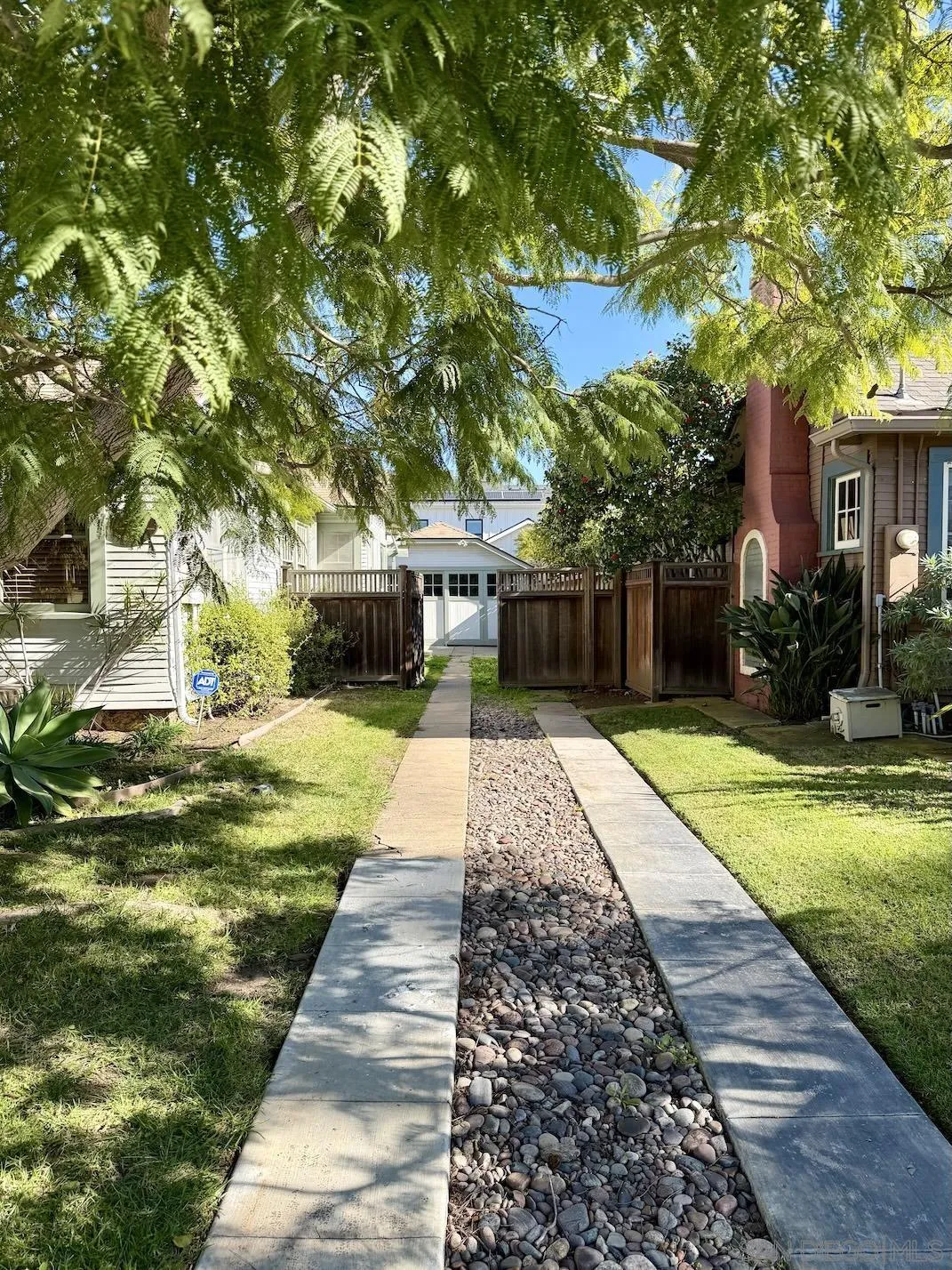 3917 Hawk Street San Diego, CA 92103 - Photo 33 of 40 a front view of a house with a yard and a garden