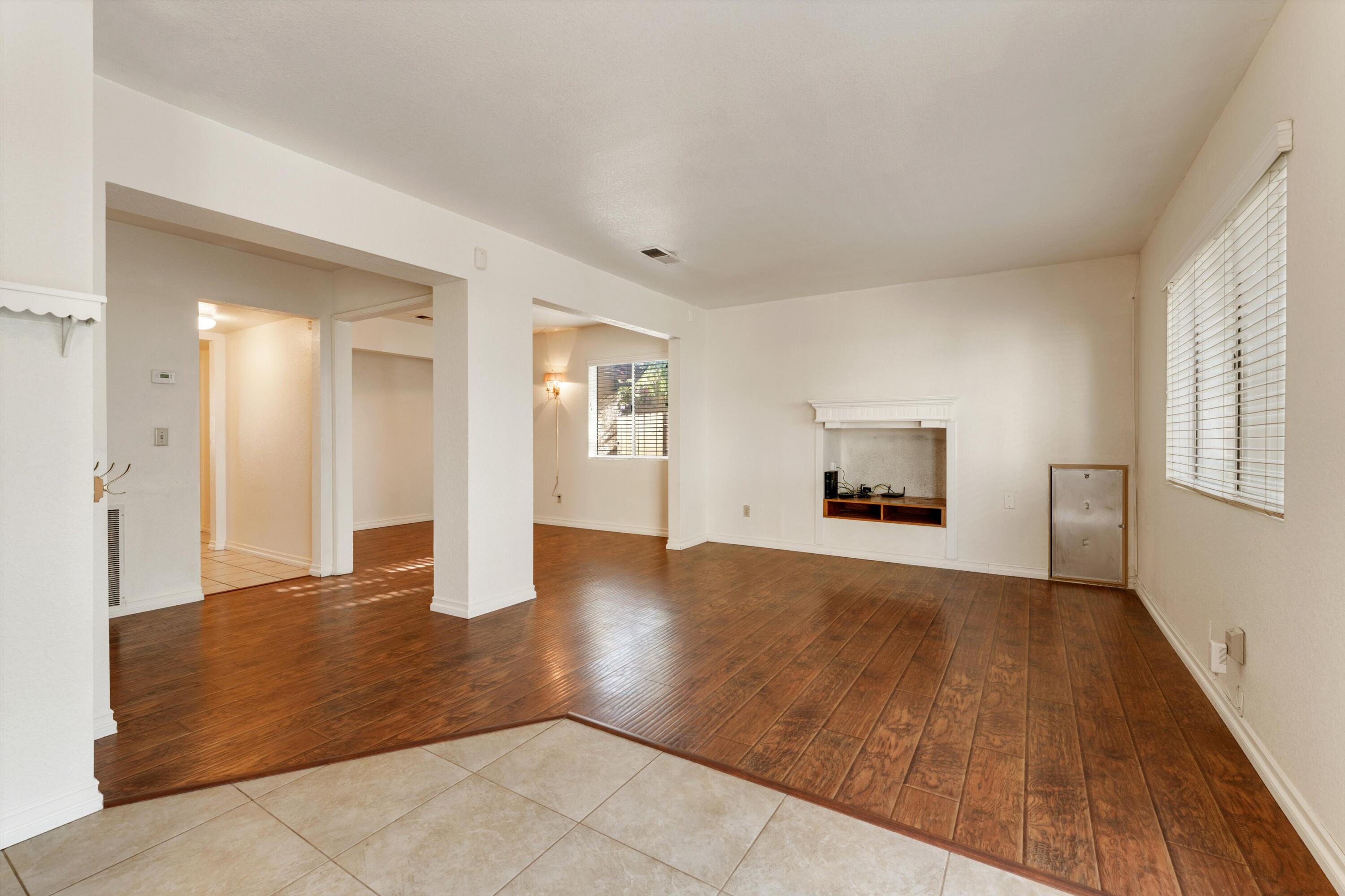 3229 Quarry Road Palmdale, CA 93550 - Photo 15 of 32 a view of an empty room with window and wooden floor