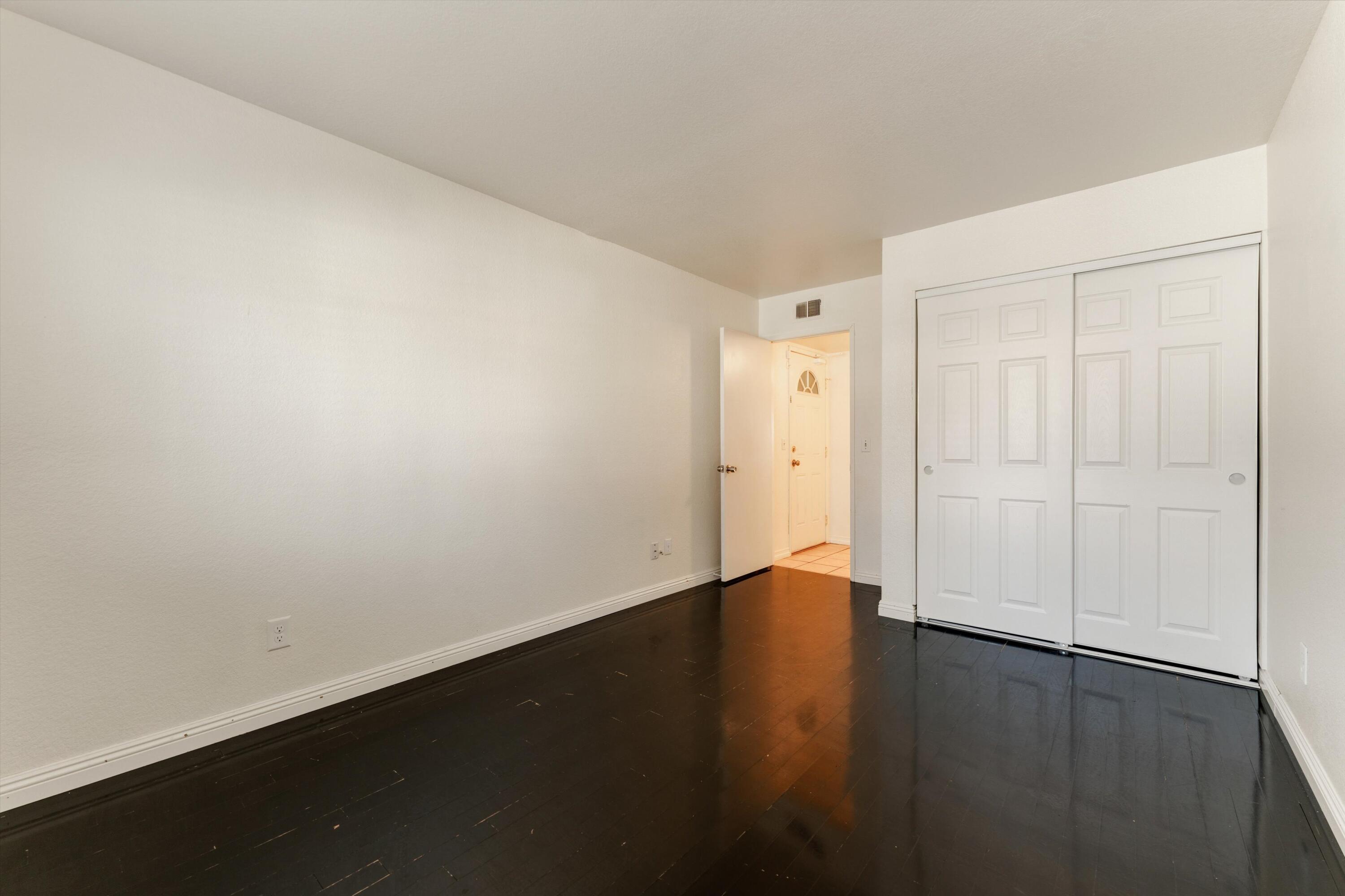 3229 Quarry Road Palmdale, CA 93550 - Photo 21 of 32 an empty room with wooden floor and closet area