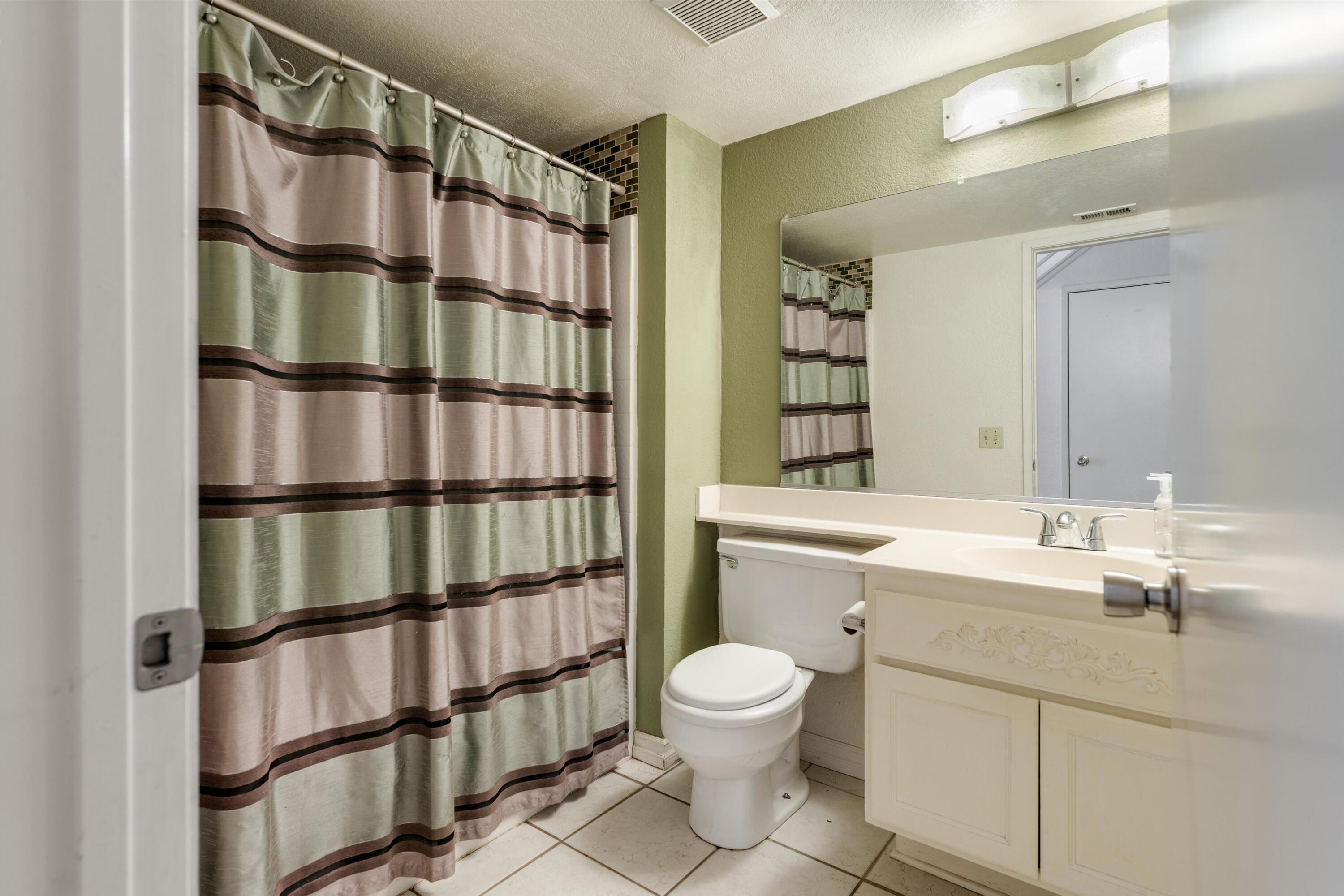 3229 Quarry Road Palmdale, CA 93550 - Photo 23 of 32 a bathroom with a sink a toilet and shower