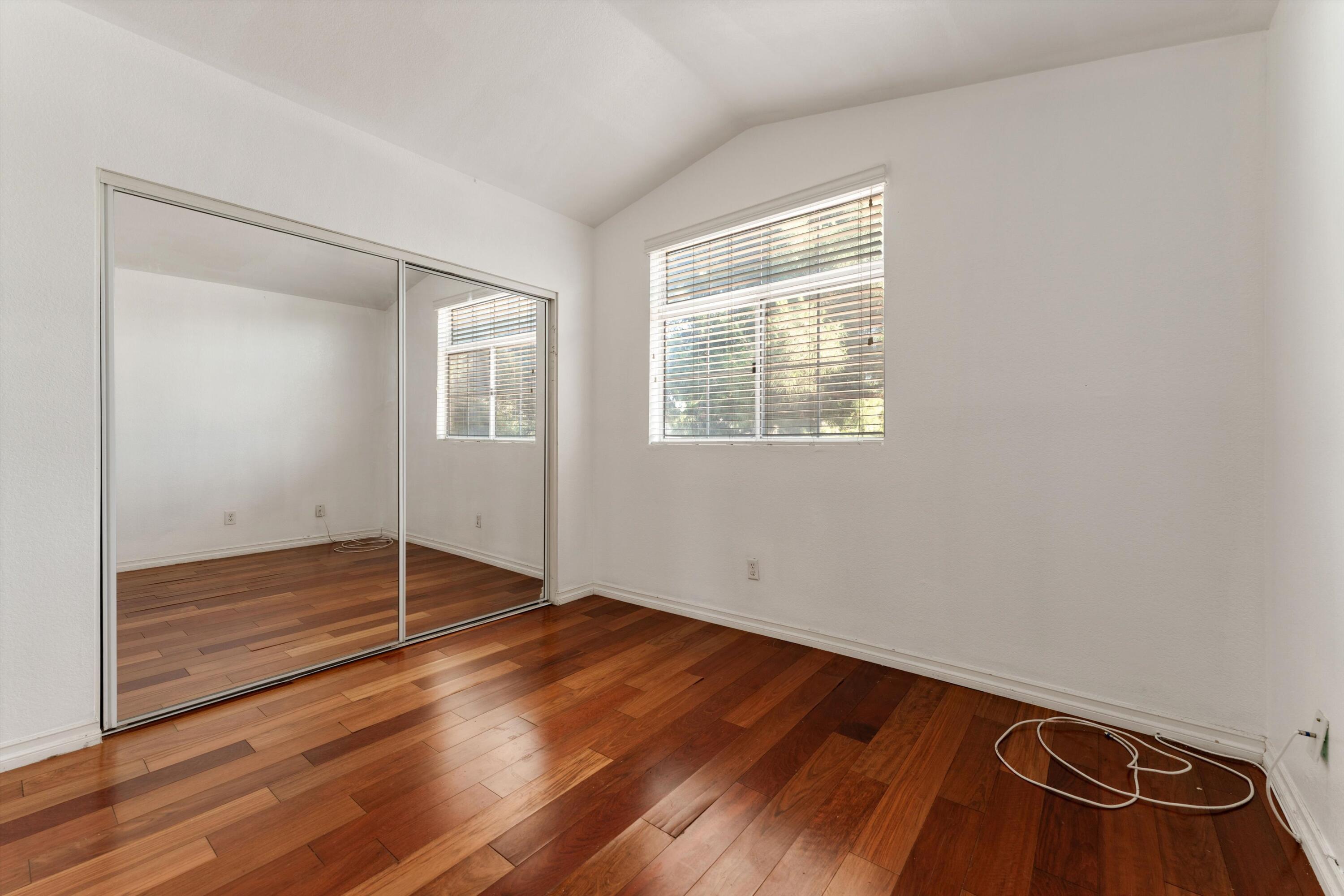 3229 Quarry Road Palmdale, CA 93550 - Photo 27 of 32 an empty room with wooden floor and windows