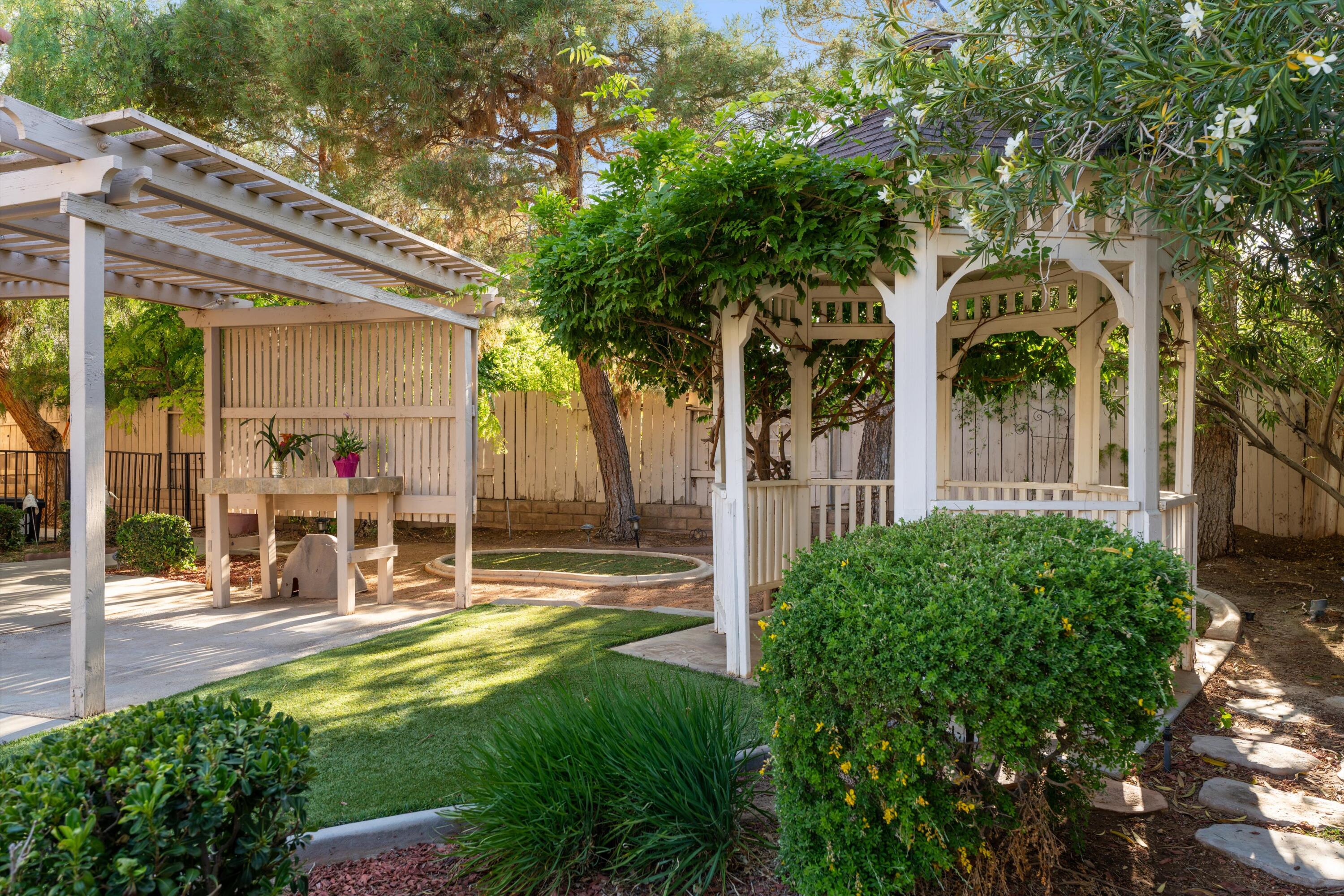 3229 Quarry Road Palmdale, CA 93550 - Photo 5 of 32 a view of a patio with table and chairs and a large tree