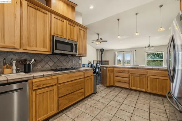 a kitchen with stainless steel appliances granite countertop a sink and cabinets