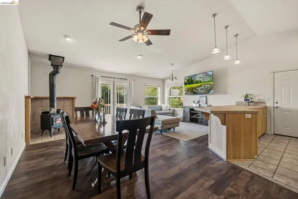 a view of a dining room with furniture and a chandelier