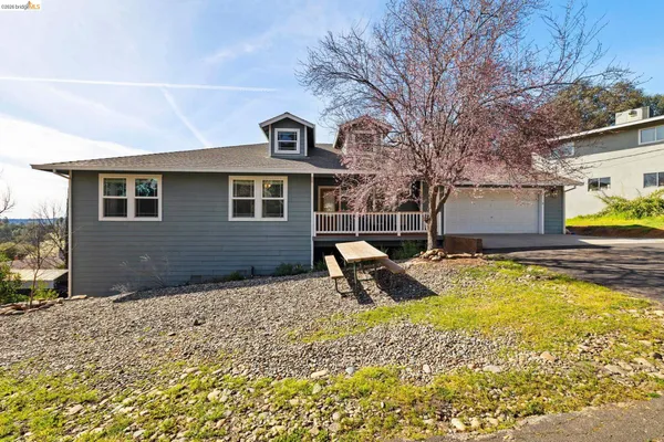 a view of a house with backyard and sitting area