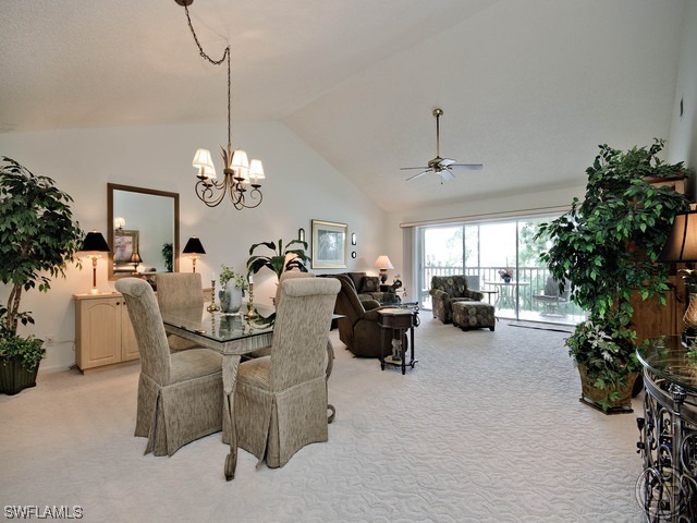 4580 Andover Way Naples, FL 34112 - Photo 5 of 12 a living room with furniture and a chandelier