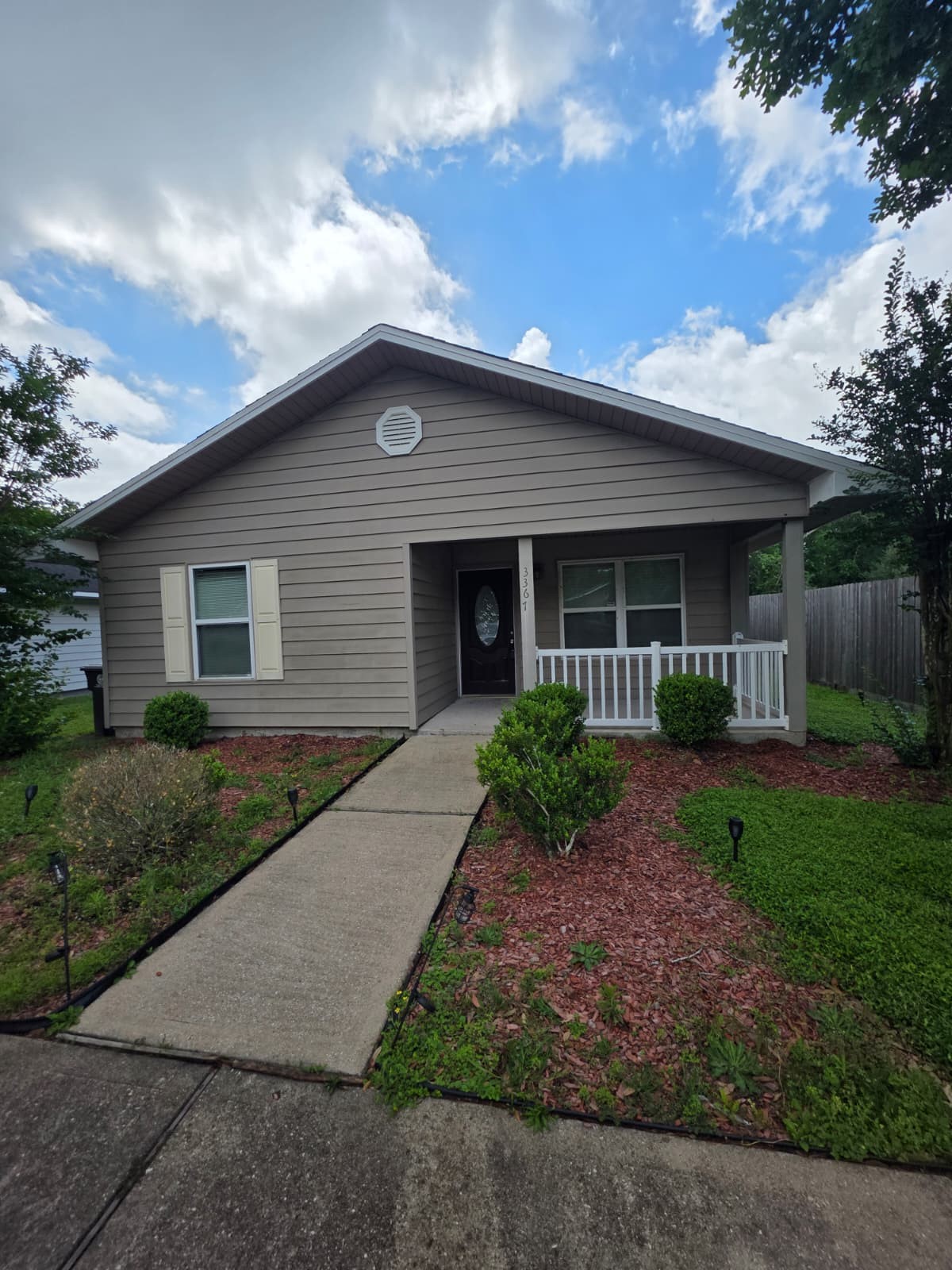 a front view of a house with garden