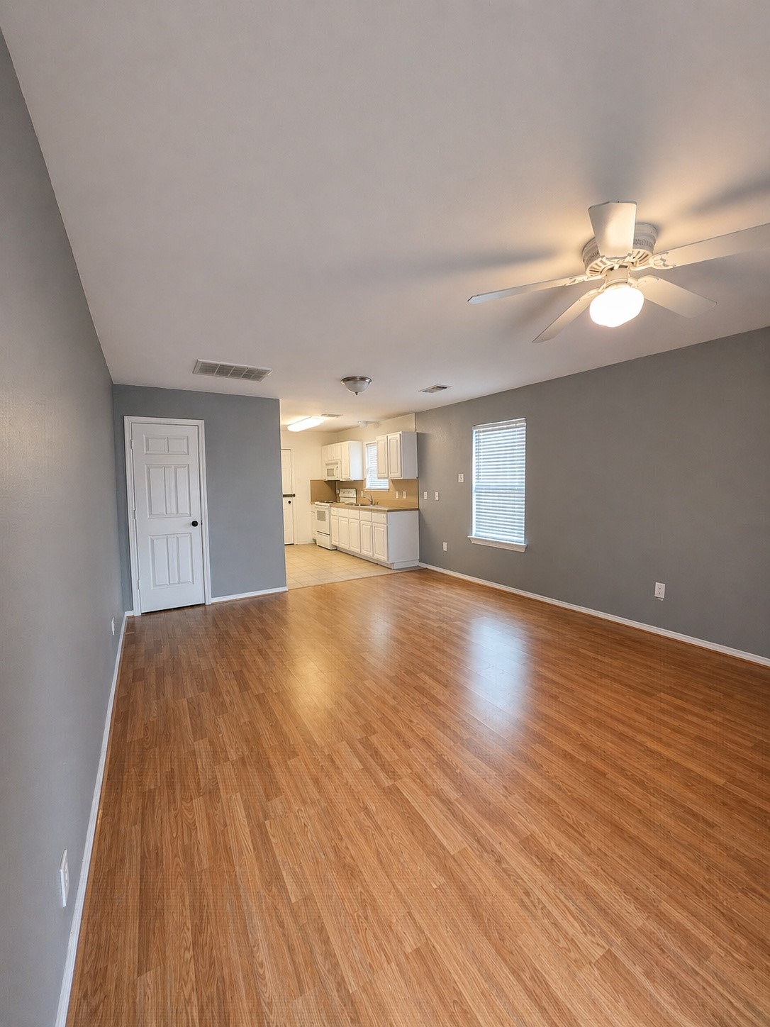 3367 Angel Lane Houston, TX 77045 - Photo 2 of 6 a view of empty room with wooden floor and fan