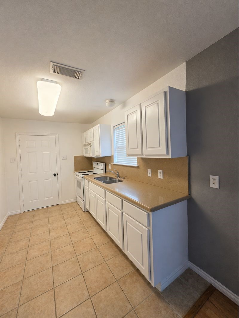3367 Angel Lane Houston, TX 77045 - Photo 3 of 6 a kitchen with a cabinets and counter space