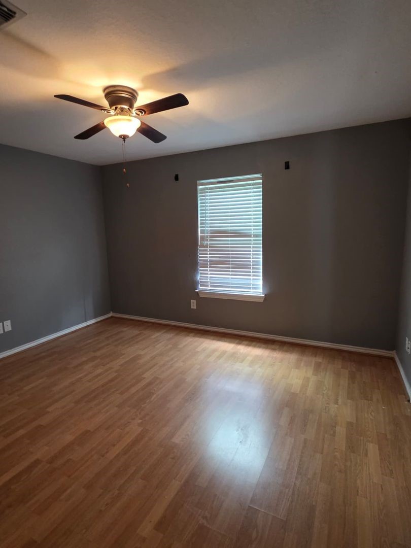 3367 Angel Lane Houston, TX 77045 - Photo 4 of 6 a view of an empty room with wooden floor and a window