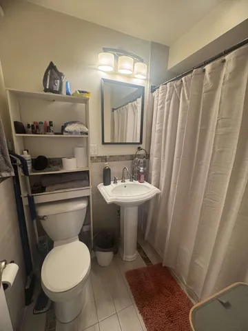 a bathroom with a sink a toilet and a mirror