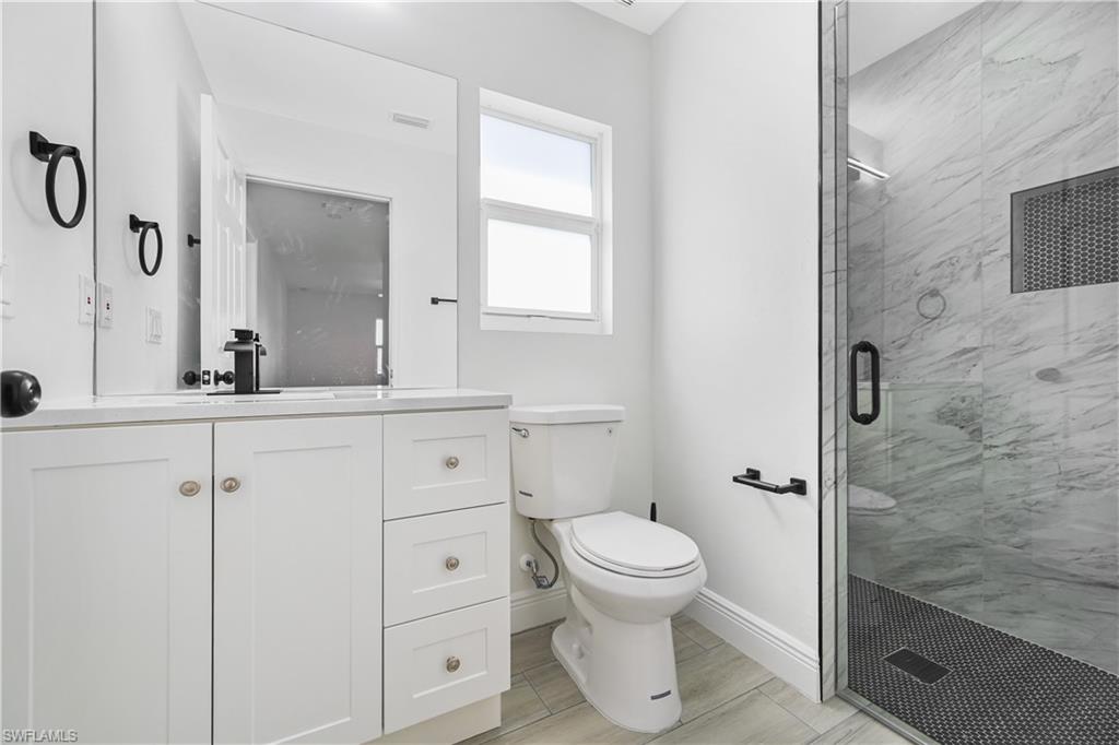 4448 18th Avenue Southwest Naples, FL 34116 - Photo 12 of 28 a bathroom with a toilet sink and a mirror