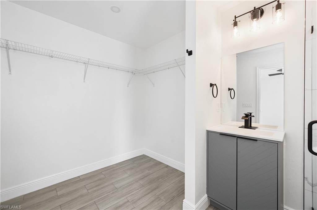 4448 18th Avenue Southwest Naples, FL 34116 - Photo 16 of 28 a view of cabinets and wooden floor
