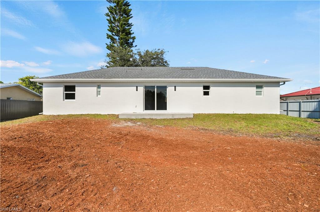 4448 18th Avenue Southwest Naples, FL 34116 - Photo 23 of 28 a front view of house with yard and trees in the background