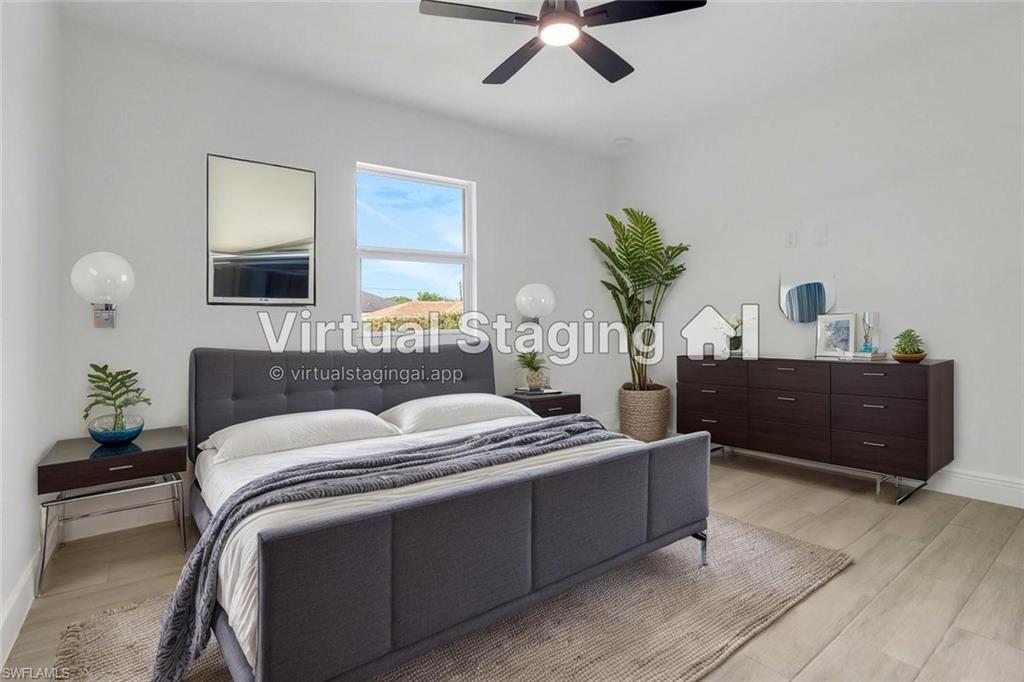 4448 18th Avenue Southwest Naples, FL 34116 - Photo 25 of 28 a living room with a bed furniture and a potted plant