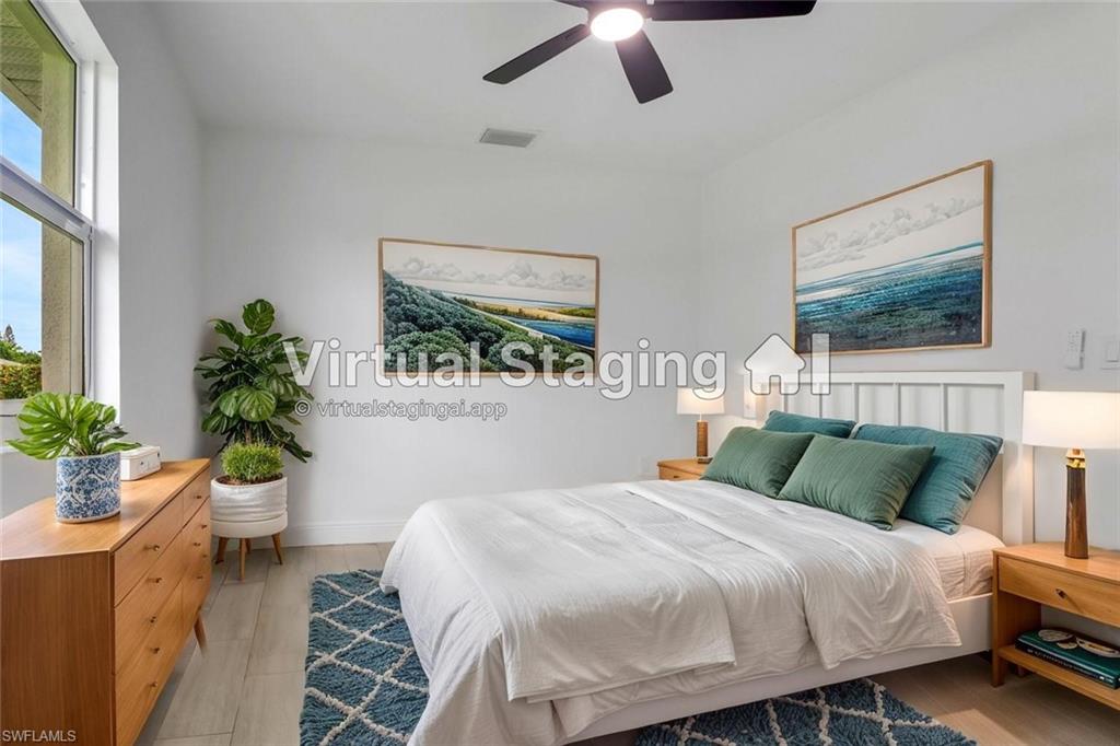 4448 18th Avenue Southwest Naples, FL 34116 - Photo 26 of 28 a bedroom with a bed and a potted plant