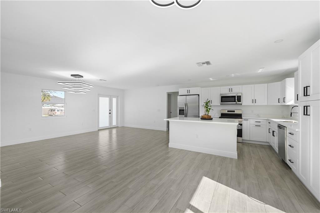 4448 18th Avenue Southwest Naples, FL 34116 - Photo 7 of 28 a view of kitchen with sink microwave refrigerator and cabinets