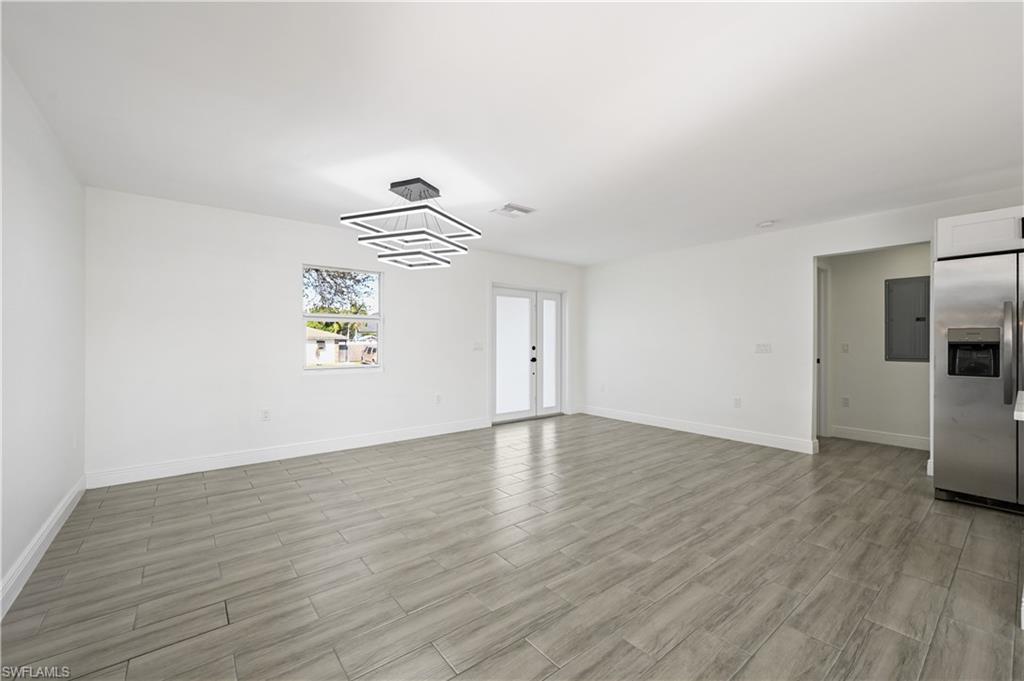 4448 18th Avenue Southwest Naples, FL 34116 - Photo 8 of 28 a view of empty room with wooden floor and window