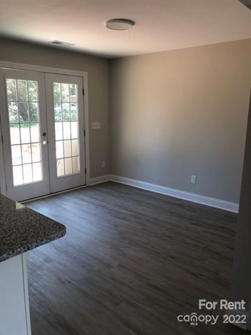1307 Filbert Street Salisbury, NC 28144 - Photo 2 of 10 an empty room with wooden floor and windows