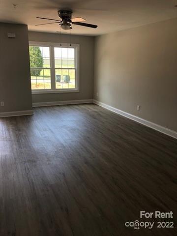 1307 Filbert Street Salisbury, NC 28144 - Photo 3 of 10 an empty room with wooden floor and windows