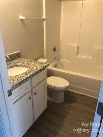 1307 Filbert Street Salisbury, NC 28144 - Photo 5 of 10 a bathroom with a granite countertop toilet a sink and bathtub