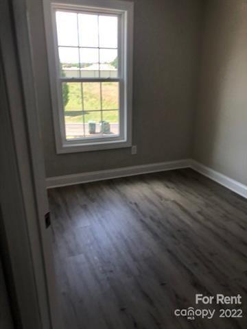 1307 Filbert Street Salisbury, NC 28144 - Photo 6 of 10 an empty room with wooden floor and windows