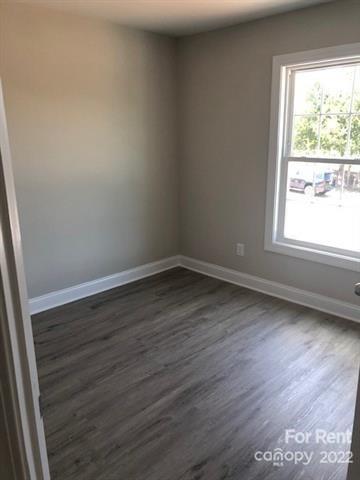 1307 Filbert Street Salisbury, NC 28144 - Photo 7 of 10 an empty room with wooden floor and windows
