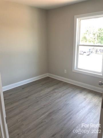 1307 Filbert Street Salisbury, NC 28144 - Photo 8 of 10 an empty room with wooden floor and windows